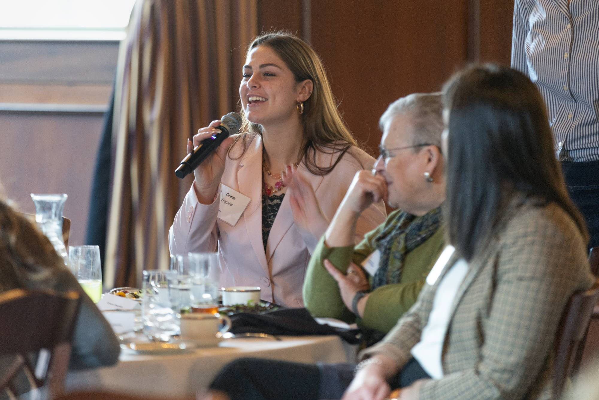 Student asks a question during luncheon